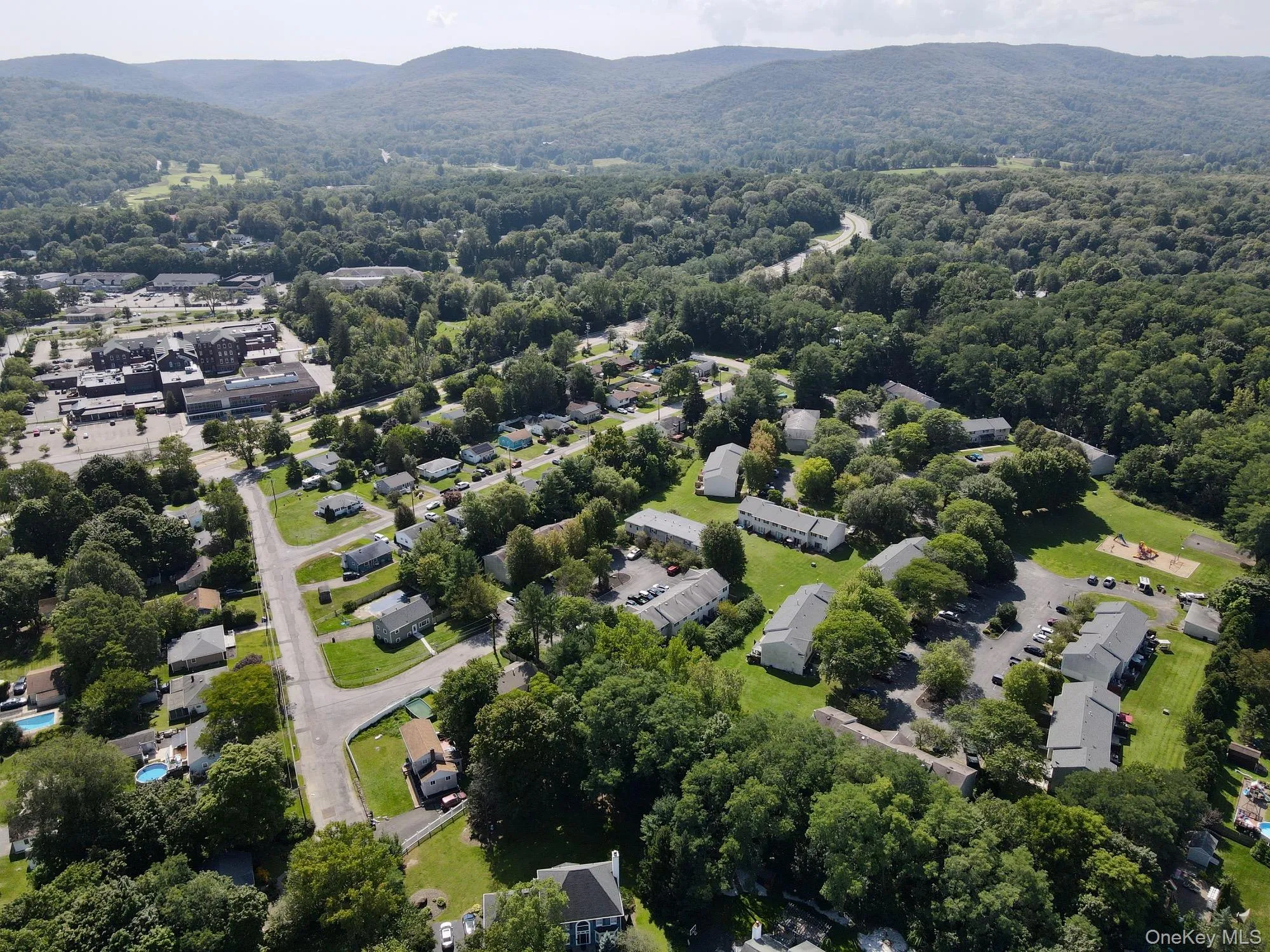 Aerial perspective of suburban area featuring a mountain backdrop Aerial perspective of suburban area featuring a mountain backdrop