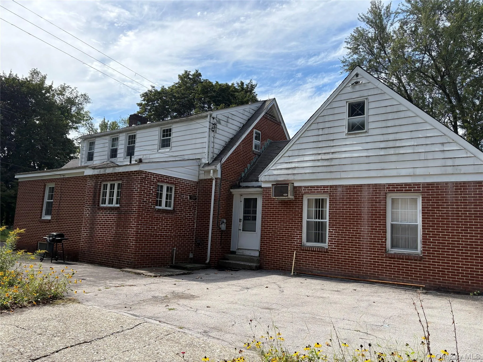 Back of house featuring brick siding and entry steps Back of house featuring brick siding and entry steps