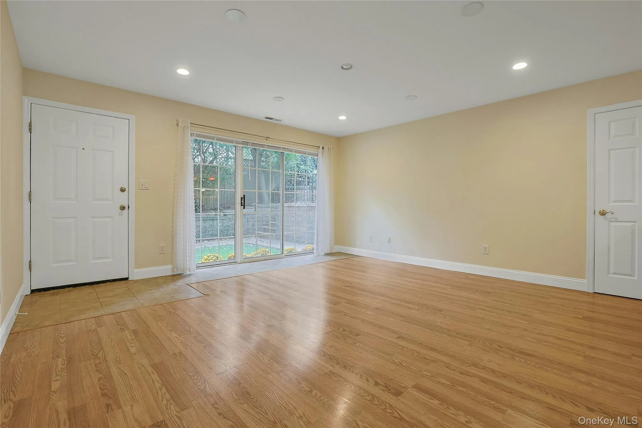 Open & airy, sunlit family room featuring wood flooring and recessed lighting throughout. Open & airy, sunlit family room featuring wood flooring and recessed lighting throughout.