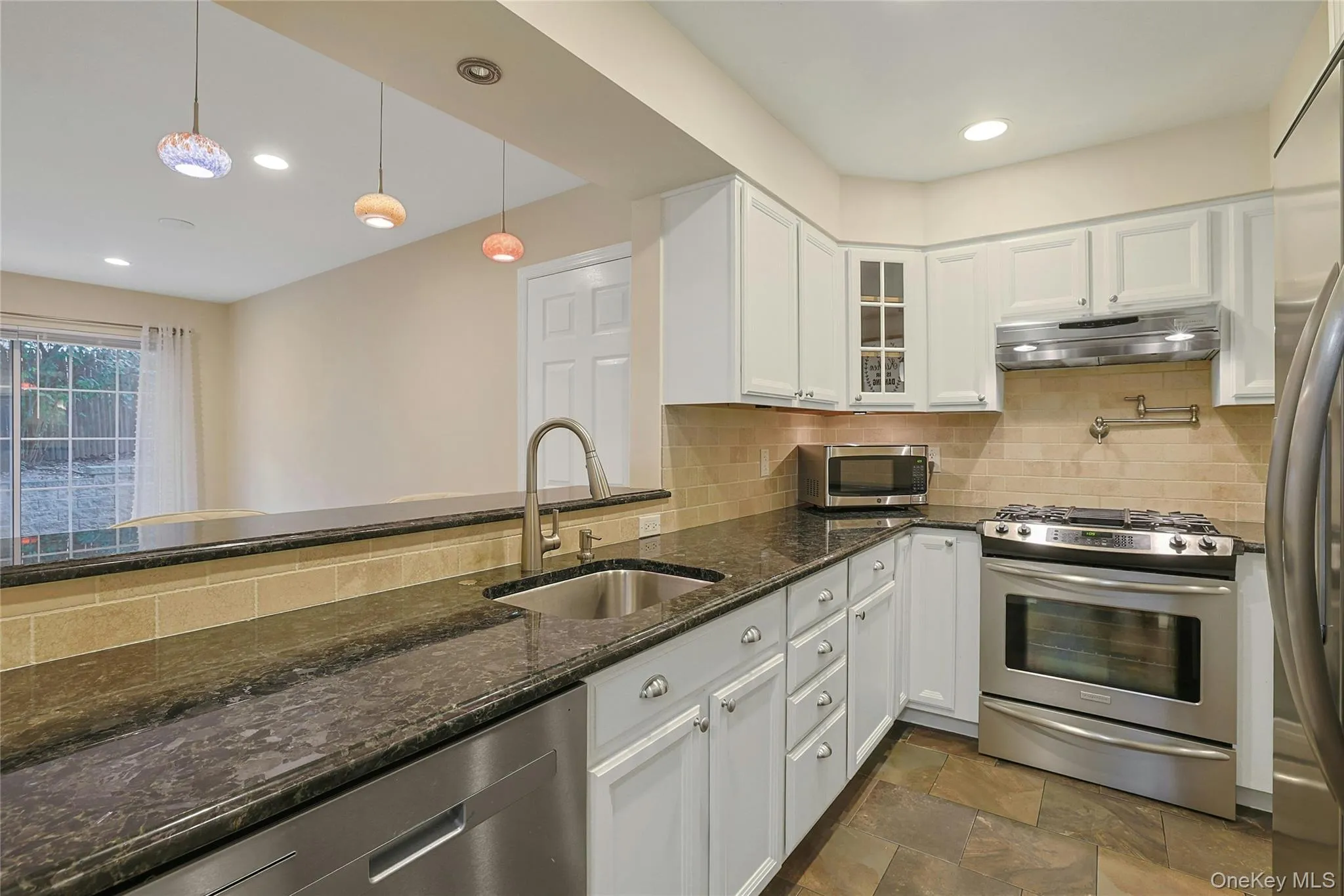 Modern and updated kitchen features stainless steel appliances, granite countertops, pot filler above stove, and amble cabinetry. Modern and updated kitchen features stainless steel appliances, granite countertops, pot filler above stove, and amble cabinetry.