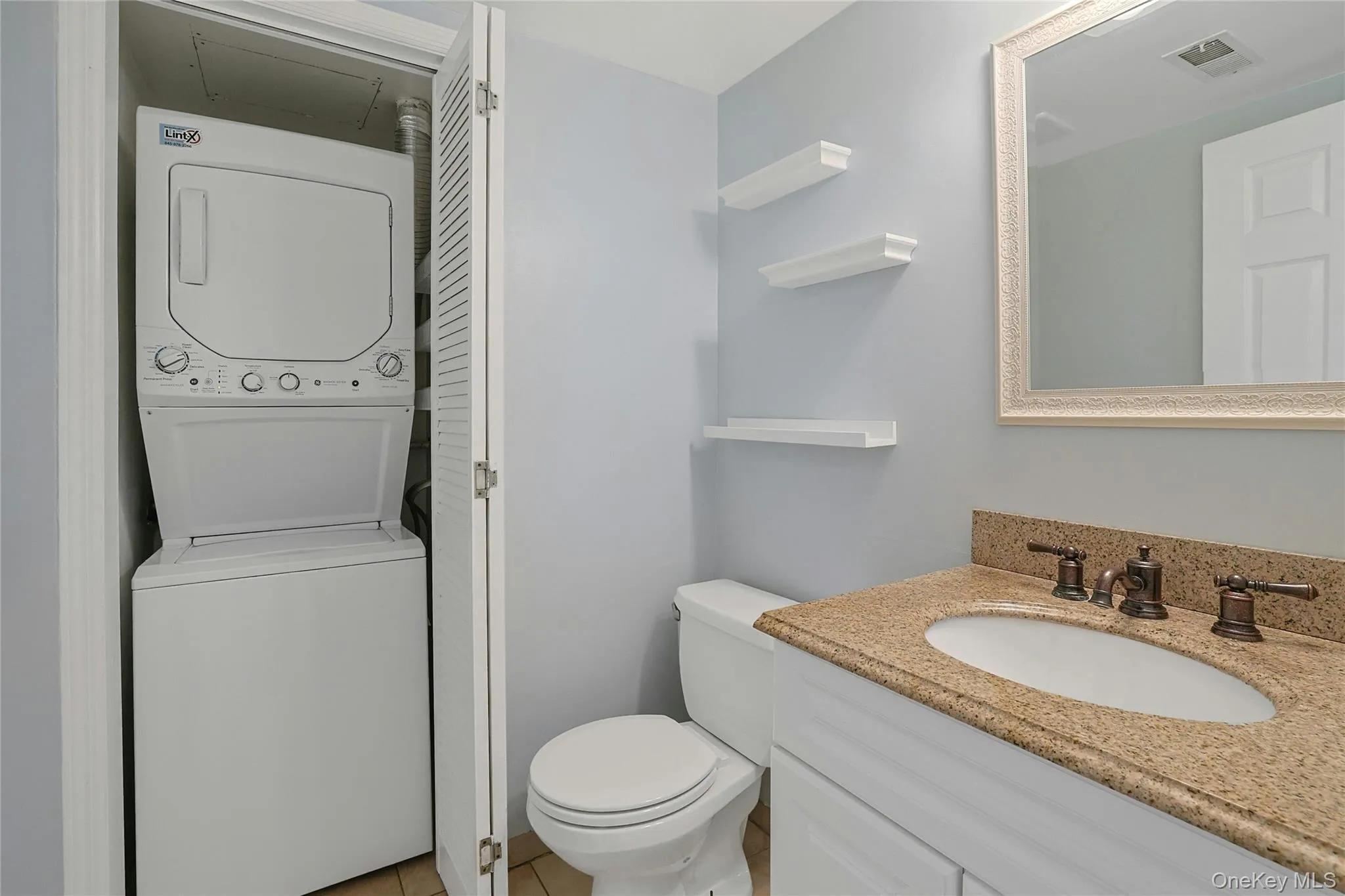 Powder Room/Half bathroom featuring washer and dryer. Powder Room/Half bathroom featuring washer and dryer.