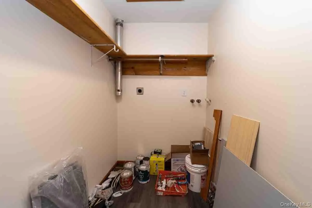 Laundry room featuring hookup for a washing machine, electric dryer hookup, and dark wood-style flooring Laundry room featuring hookup for a washing machine, electric dryer hookup, and dark wood-style flooring