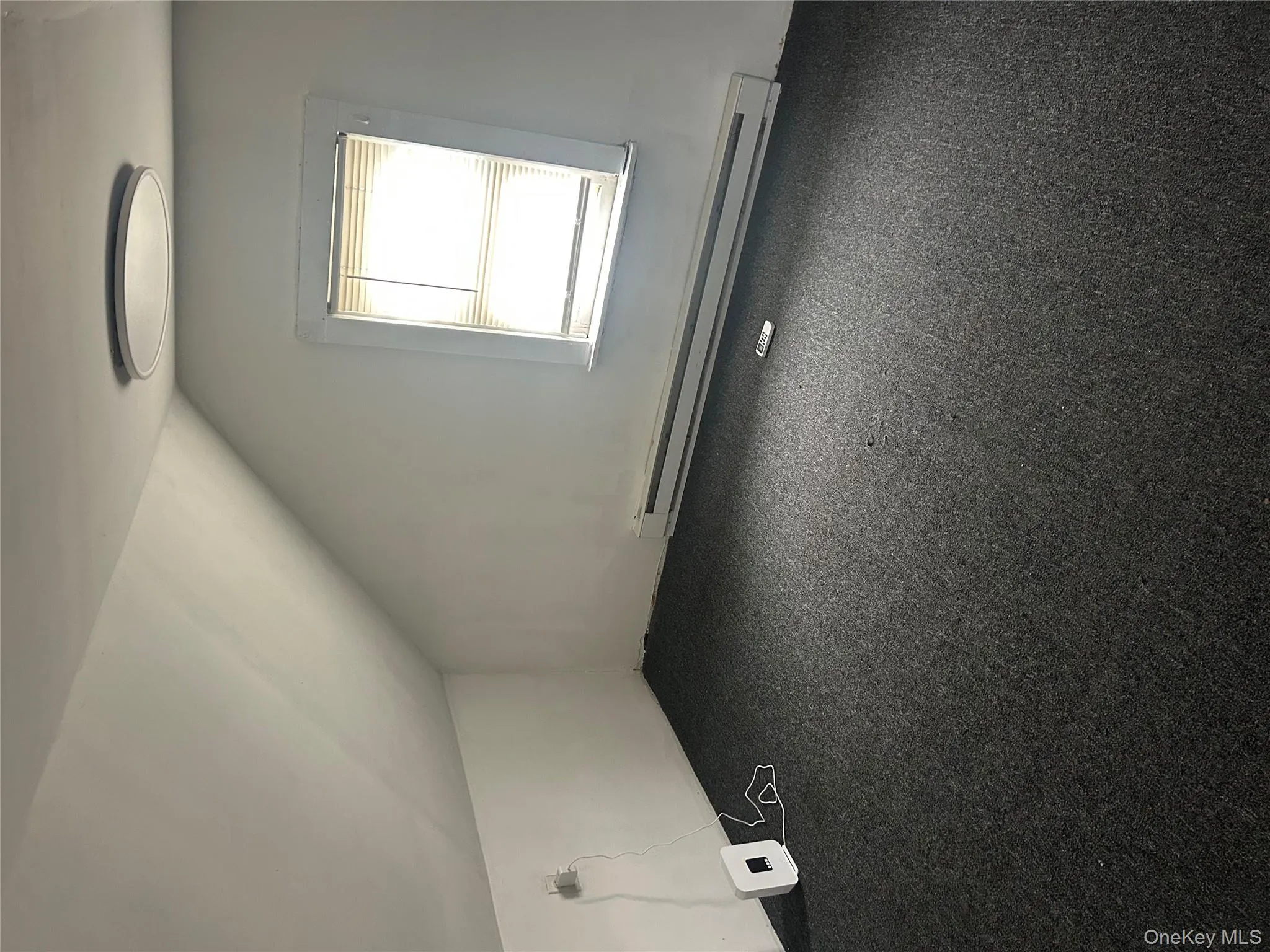 Bonus room with vaulted ceiling, baseboard heating, and carpet flooring Bonus room with vaulted ceiling, baseboard heating, and carpet flooring