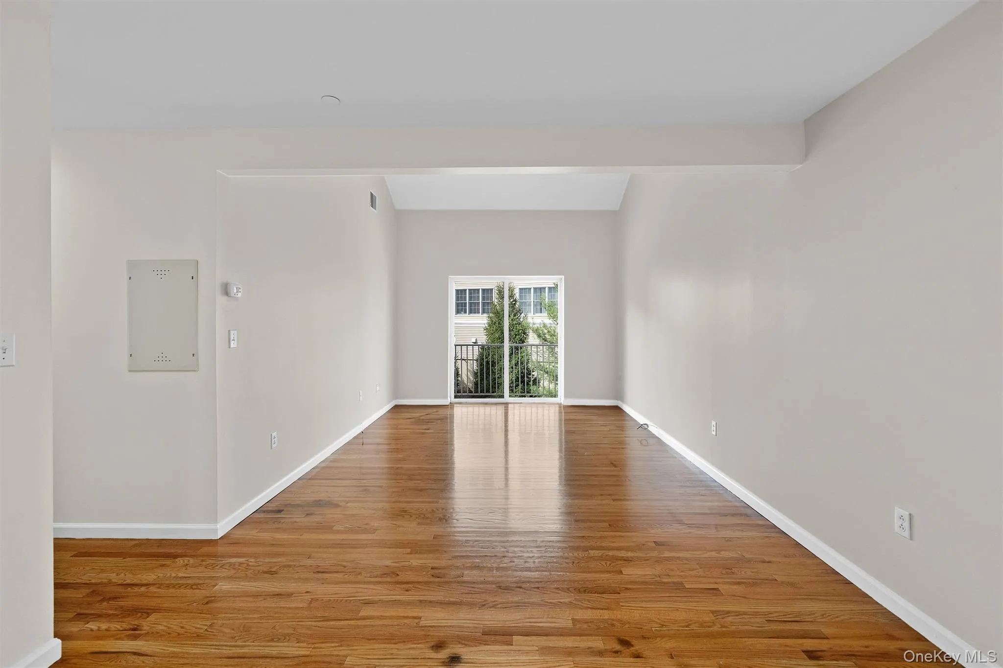 Empty room with visible vents, light wood-style flooring, and baseboards Empty room with visible vents, light wood-style flooring, and baseboards
