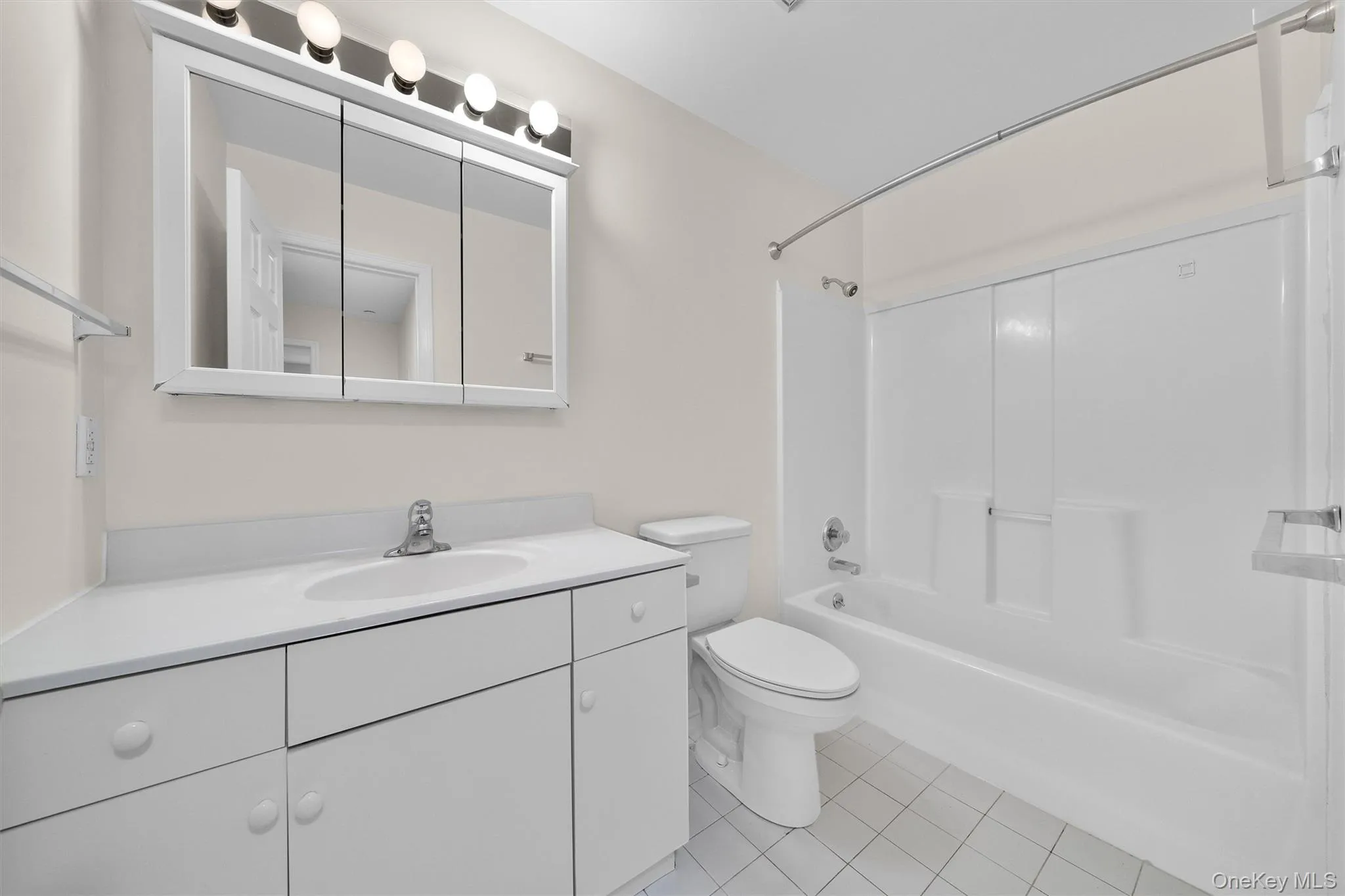 Bathroom featuring shower / bathing tub combination, toilet, tile patterned flooring, and vanity Bathroom featuring shower / bathing tub combination, toilet, tile patterned flooring, and vanity