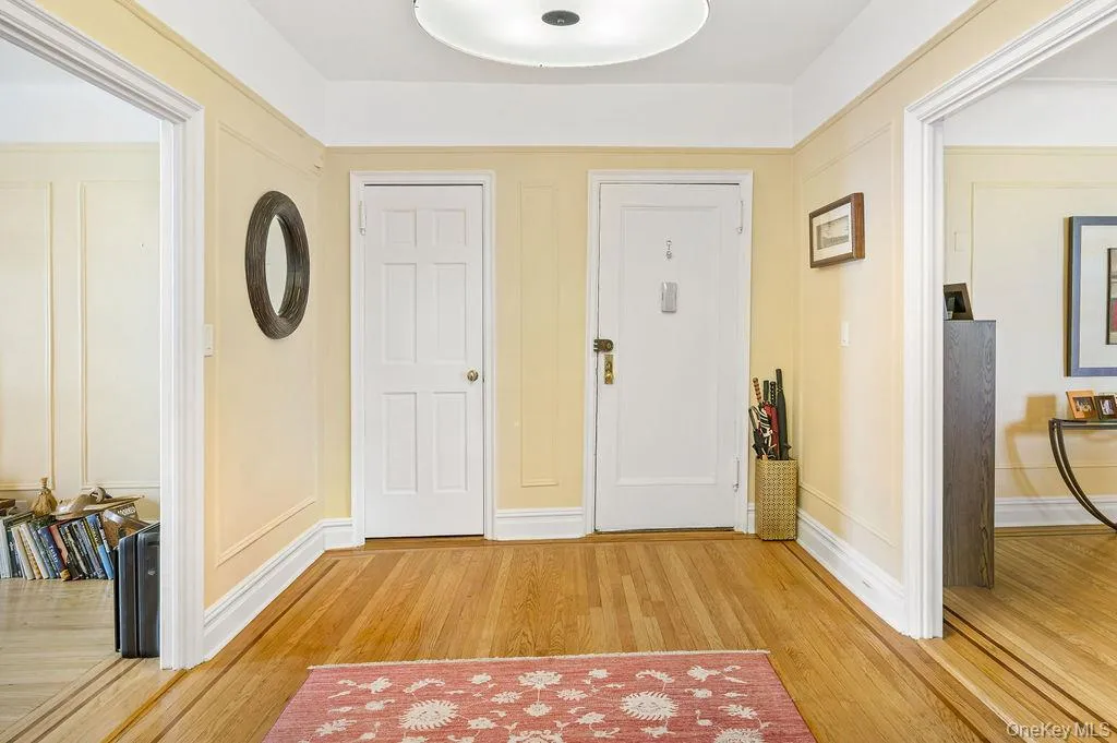 Foyer entrance featuring light wood floors and baseboards Foyer entrance featuring light wood floors and baseboards