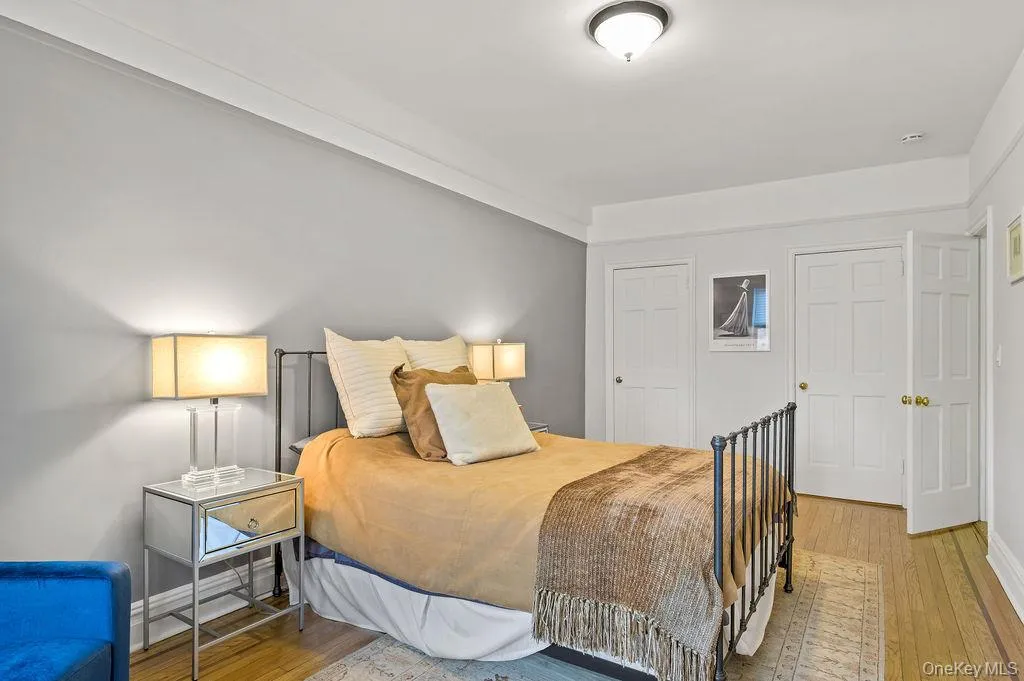 Bedroom featuring wood-type flooring and a closet Bedroom featuring wood-type flooring and a closet