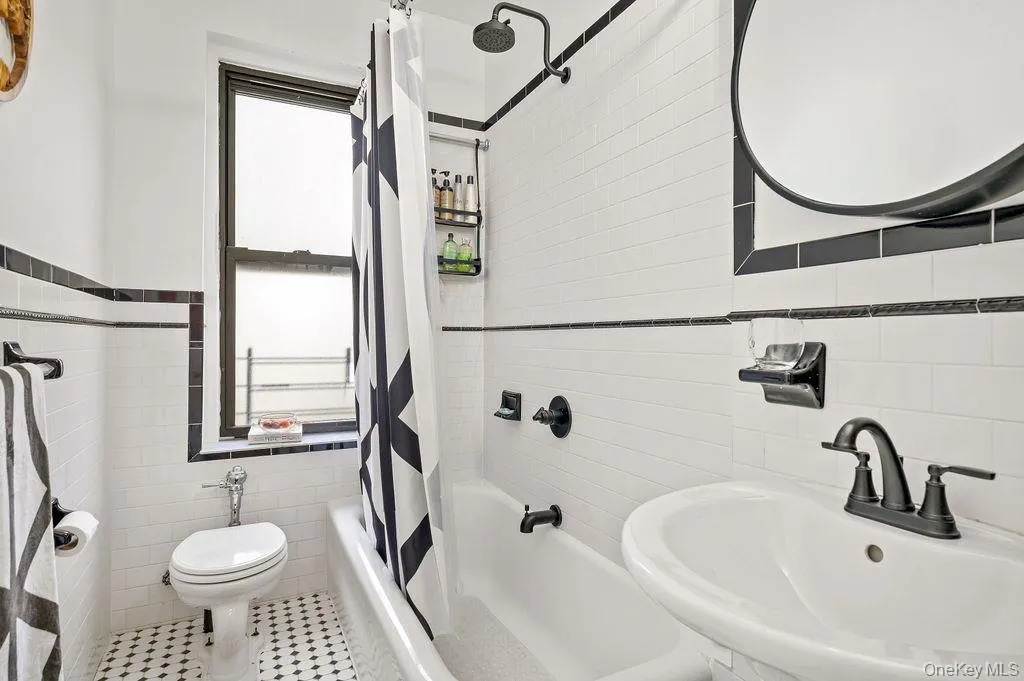 Full bath with tile walls and shower / bath combination with curtain Full bath with tile walls and shower / bath combination with curtain