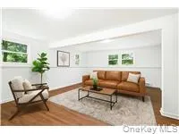 Living area featuring wood finished floors and plenty of natural light Living area featuring wood finished floors and plenty of natural light