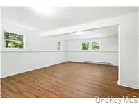 Unfurnished room with dark wood-style flooring Unfurnished room with dark wood-style flooring