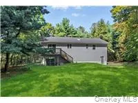 Rear view of house with a lawn and stairs Rear view of house with a lawn and stairs