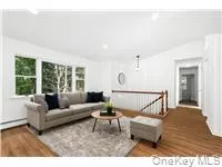 Living room featuring wood finished floors and vaulted ceiling Living room featuring wood finished floors and vaulted ceiling