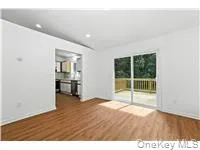 Unfurnished living room featuring dark wood-type flooring and recessed lighting Unfurnished living room featuring dark wood-type flooring and recessed lighting