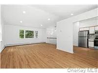 Unfurnished living room with wood finished floors and recessed lighting Unfurnished living room with wood finished floors and recessed lighting