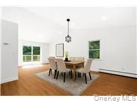 Dining area featuring vaulted ceiling and wood finished floors Dining area featuring vaulted ceiling and wood finished floors