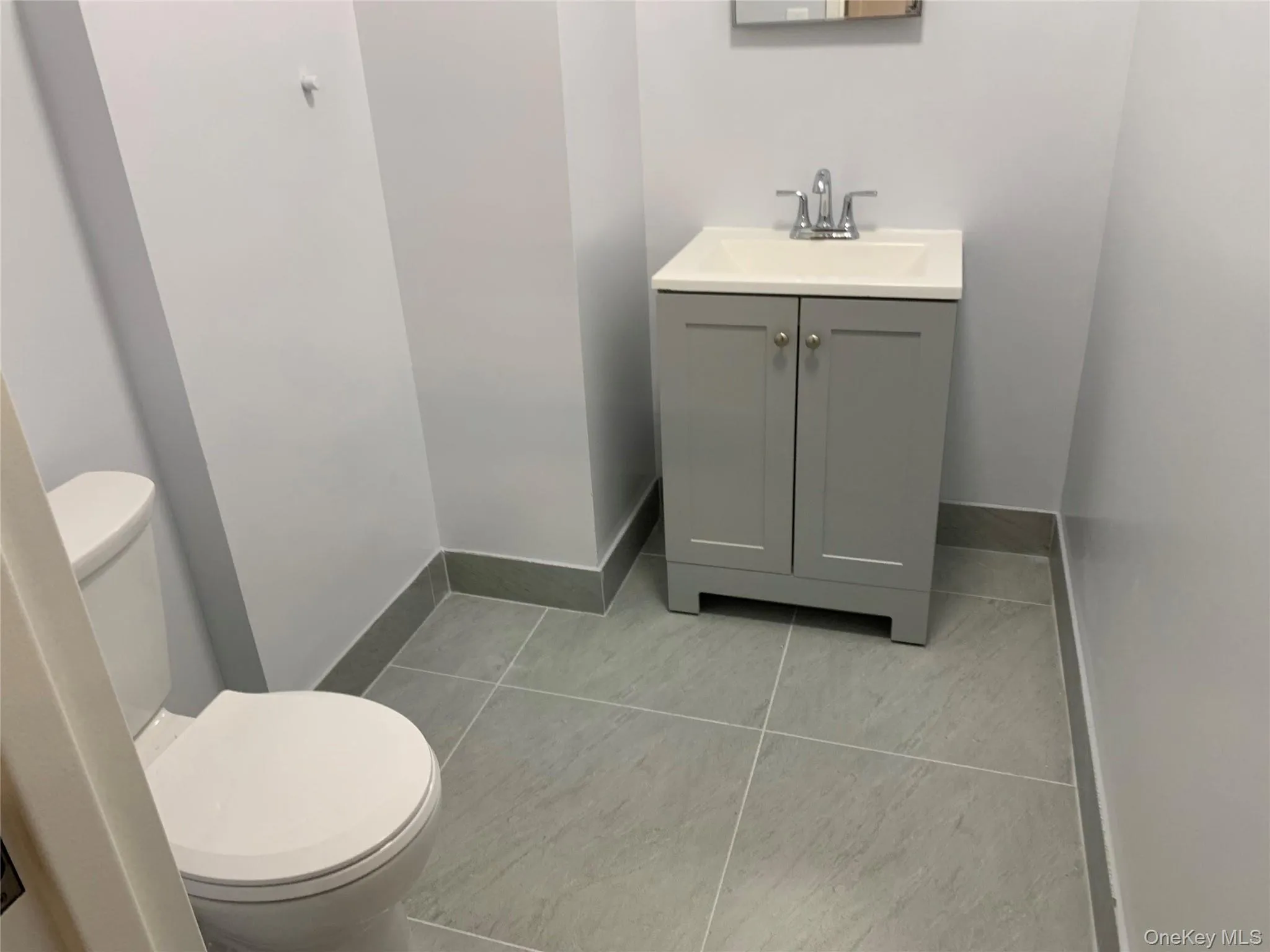 Bathroom featuring vanity and light tile patterned floors Bathroom featuring vanity and light tile patterned floors