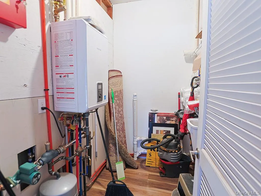 Utility room featuring tankless water heater Utility room featuring tankless water heater