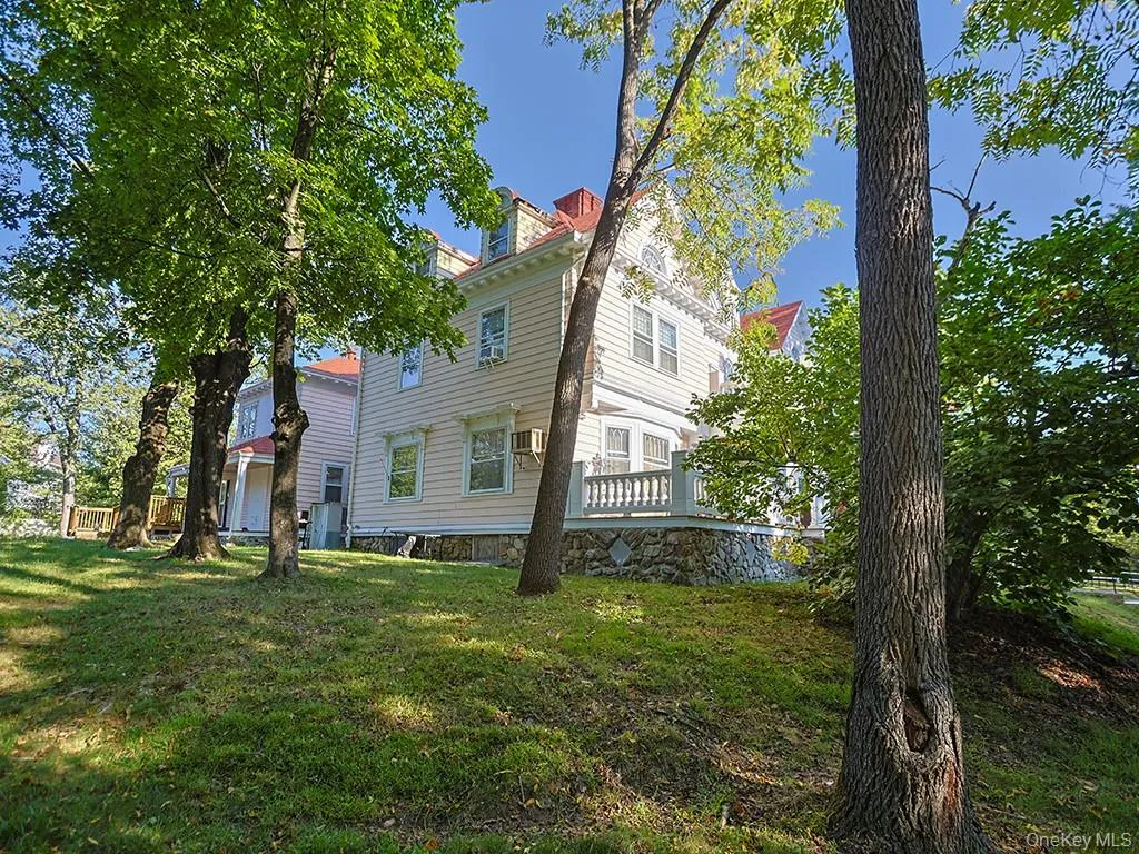 View of side of home with a chimney and a yard View of side of home with a chimney and a yard
