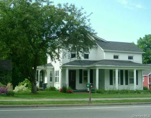 View of front of home with a porch and a front yard View of front of home with a porch and a front yard
