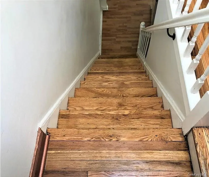 Stairway featuring wood finished floors Stairway featuring wood finished floors