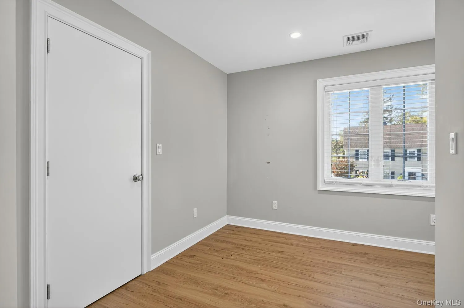Empty room with light wood finished floors and recessed lighting Empty room with light wood finished floors and recessed lighting