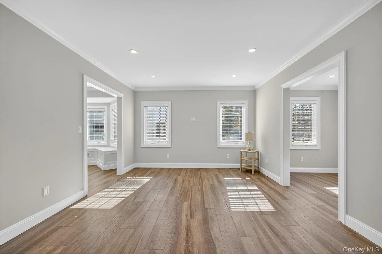 Spare room with ornamental molding, wood finished floors, and recessed lighting Spare room with ornamental molding, wood finished floors, and recessed lighting