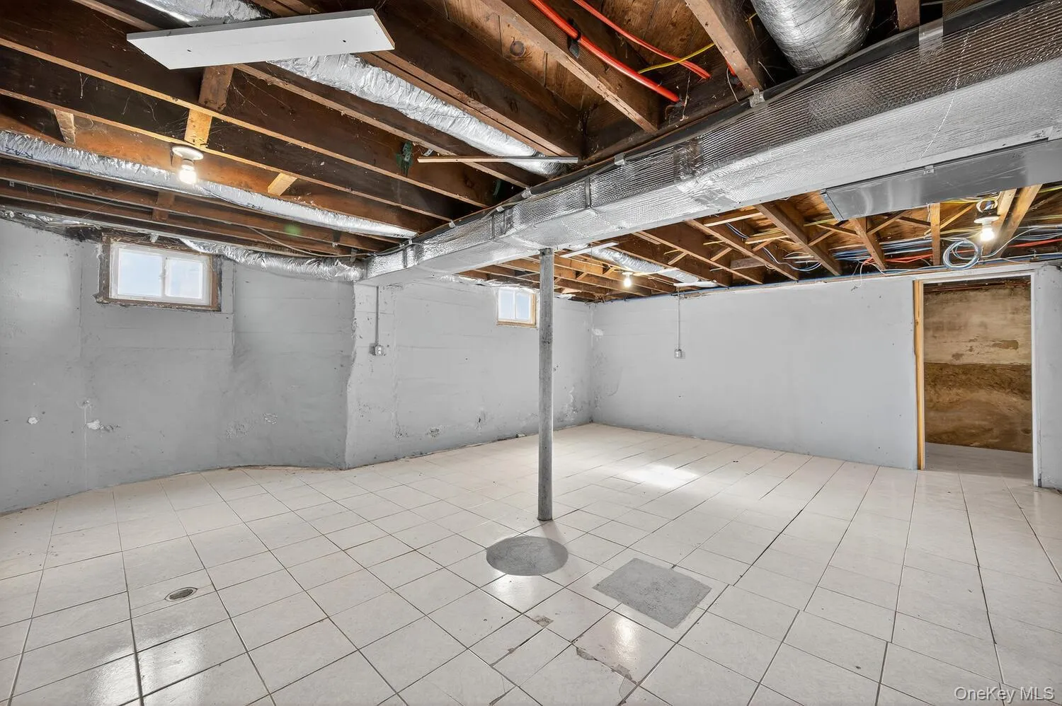 Below grade area featuring tile patterned flooring Below grade area featuring tile patterned flooring