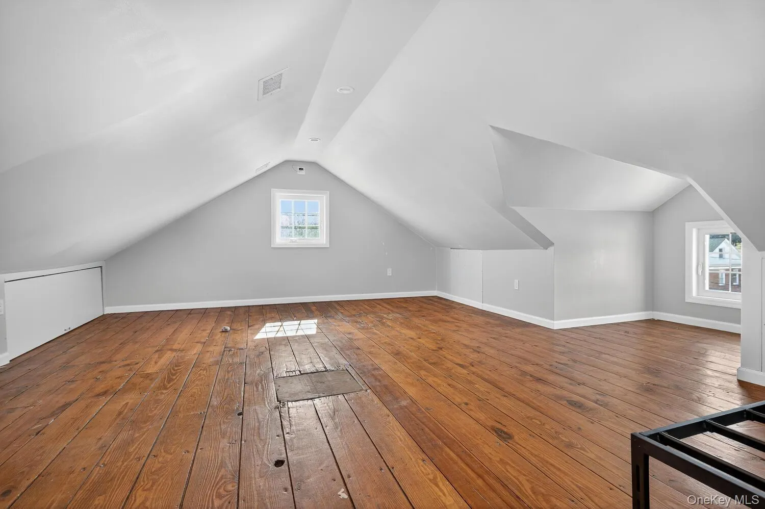 Additional living space with dark wood-style floors and vaulted ceiling Additional living space with dark wood-style floors and vaulted ceiling