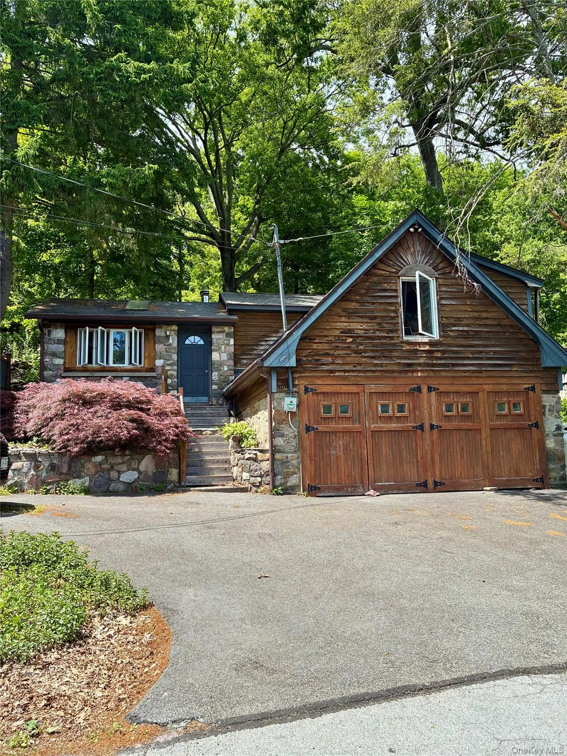 Cottage with newly paved driveway. Cottage with newly paved driveway.
