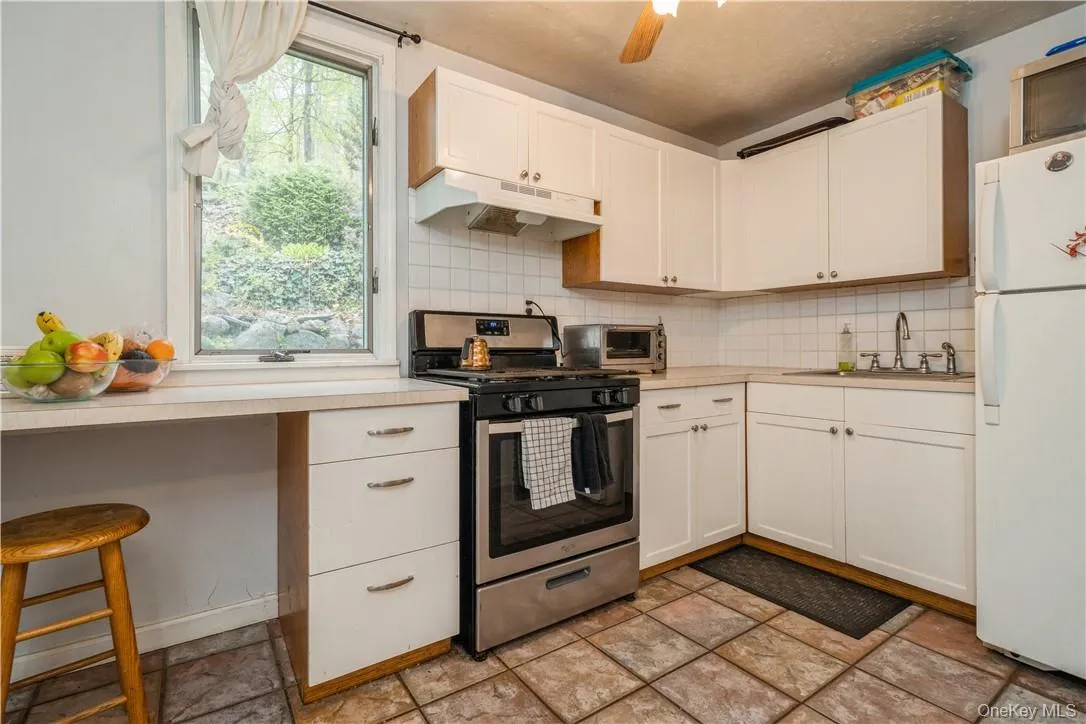 Kitchen in cottage with nice views of the tiered patio. Kitchen in cottage with nice views of the tiered patio.