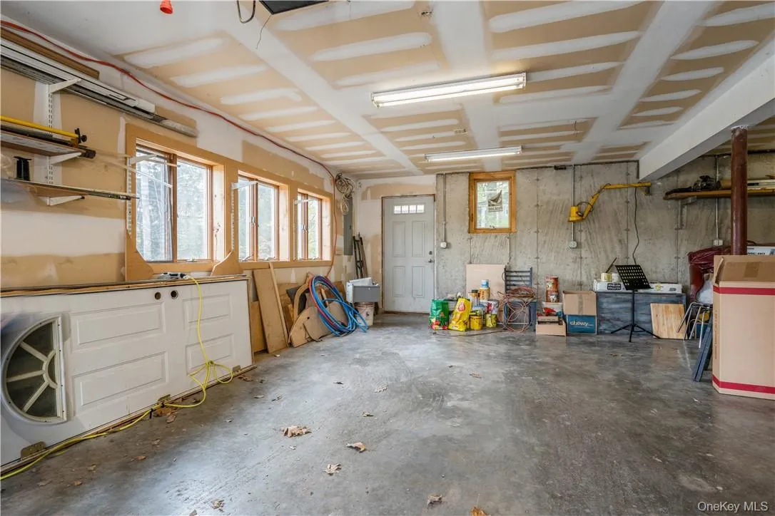 Garage fits two cars, plus workshop/storage/utilities. Garage fits two cars, plus workshop/storage/utilities.