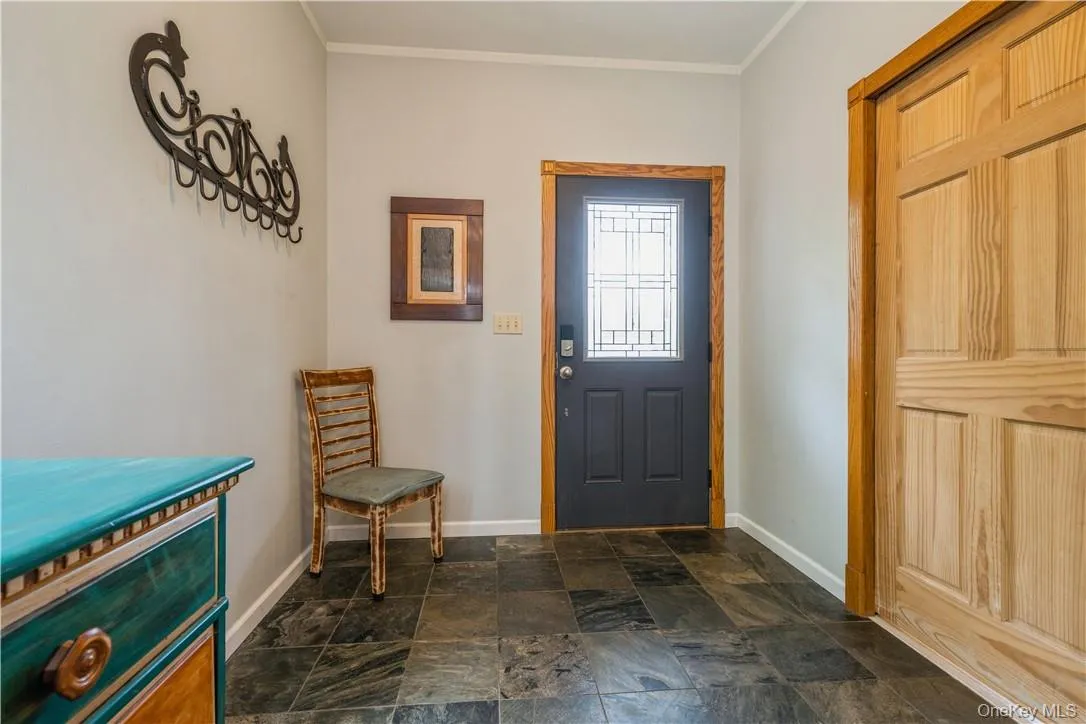 Entryway into the main house. Beautiful craftsman style front door, slate tiles, lots of light. Door on right is large full bathroom/laundry. Entryway into the main house. Beautiful craftsman style front door, slate tiles, lots of light. Door on right is large full bathroom/laundry.