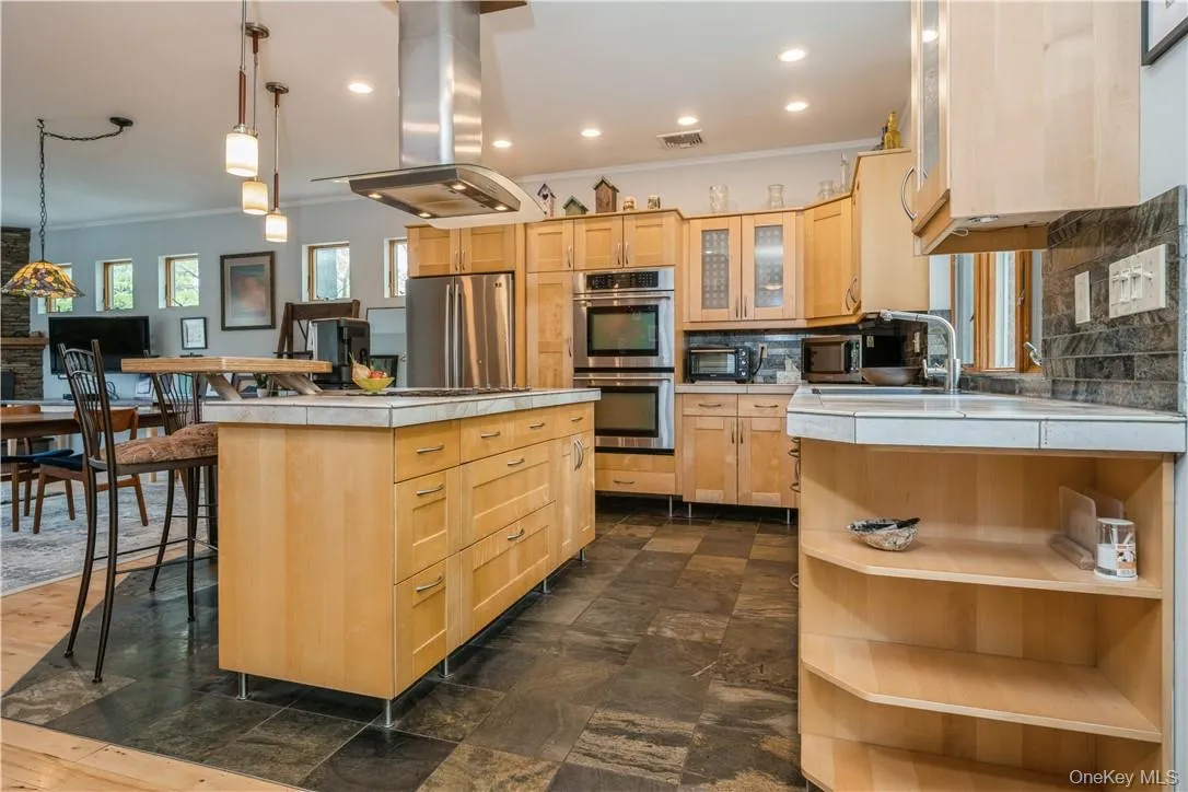 Gorgeous maple cabinetry. Earthy color palette along floors, walls and handcut slate backsplash. Gorgeous maple cabinetry. Earthy color palette along floors, walls and handcut slate backsplash.