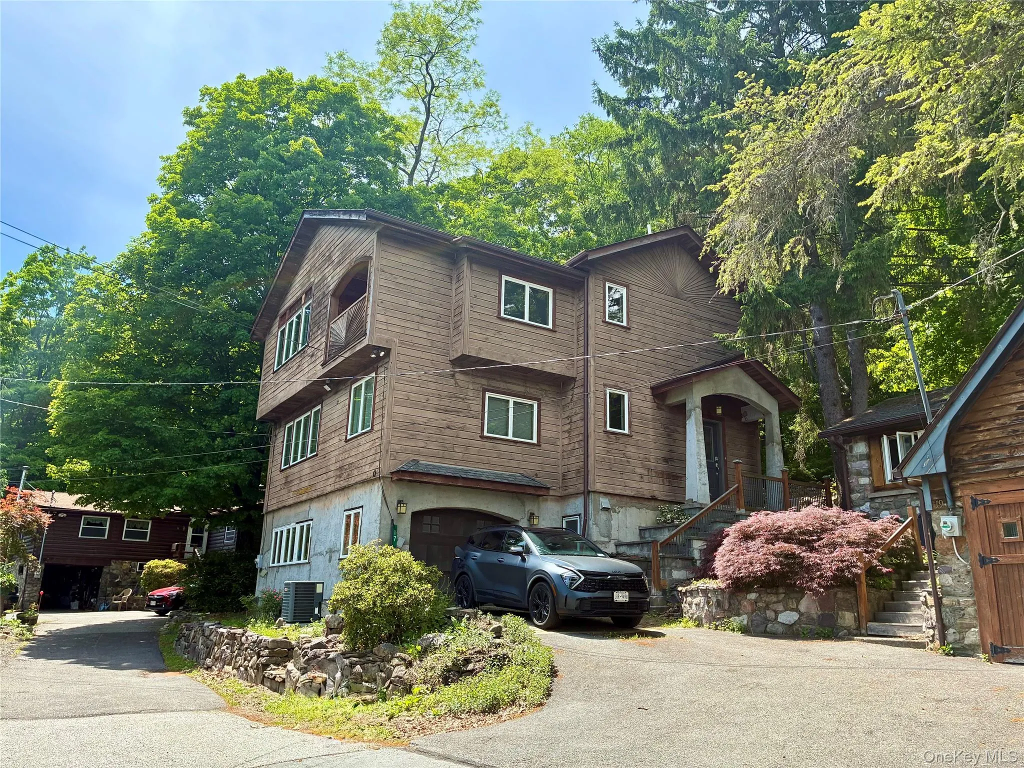 Main home features balcony off primary suite facing lake. Driveway recently paved. Main home features balcony off primary suite facing lake. Driveway recently paved.