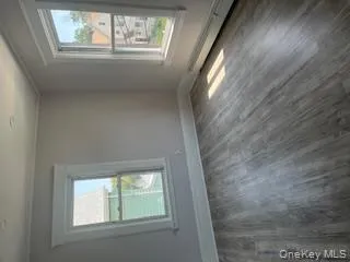 Spare room with dark wood-style flooring, a baseboard heating unit, and crown molding Spare room with dark wood-style flooring, a baseboard heating unit, and crown molding