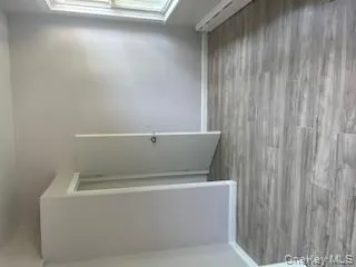 Empty room featuring light wood-style flooring and a baseboard radiator Empty room featuring light wood-style flooring and a baseboard radiator