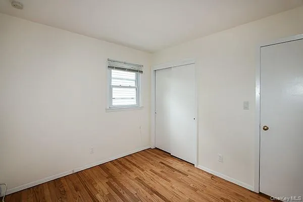 Unfurnished bedroom with light wood-style flooring and a closet Unfurnished bedroom with light wood-style flooring and a closet