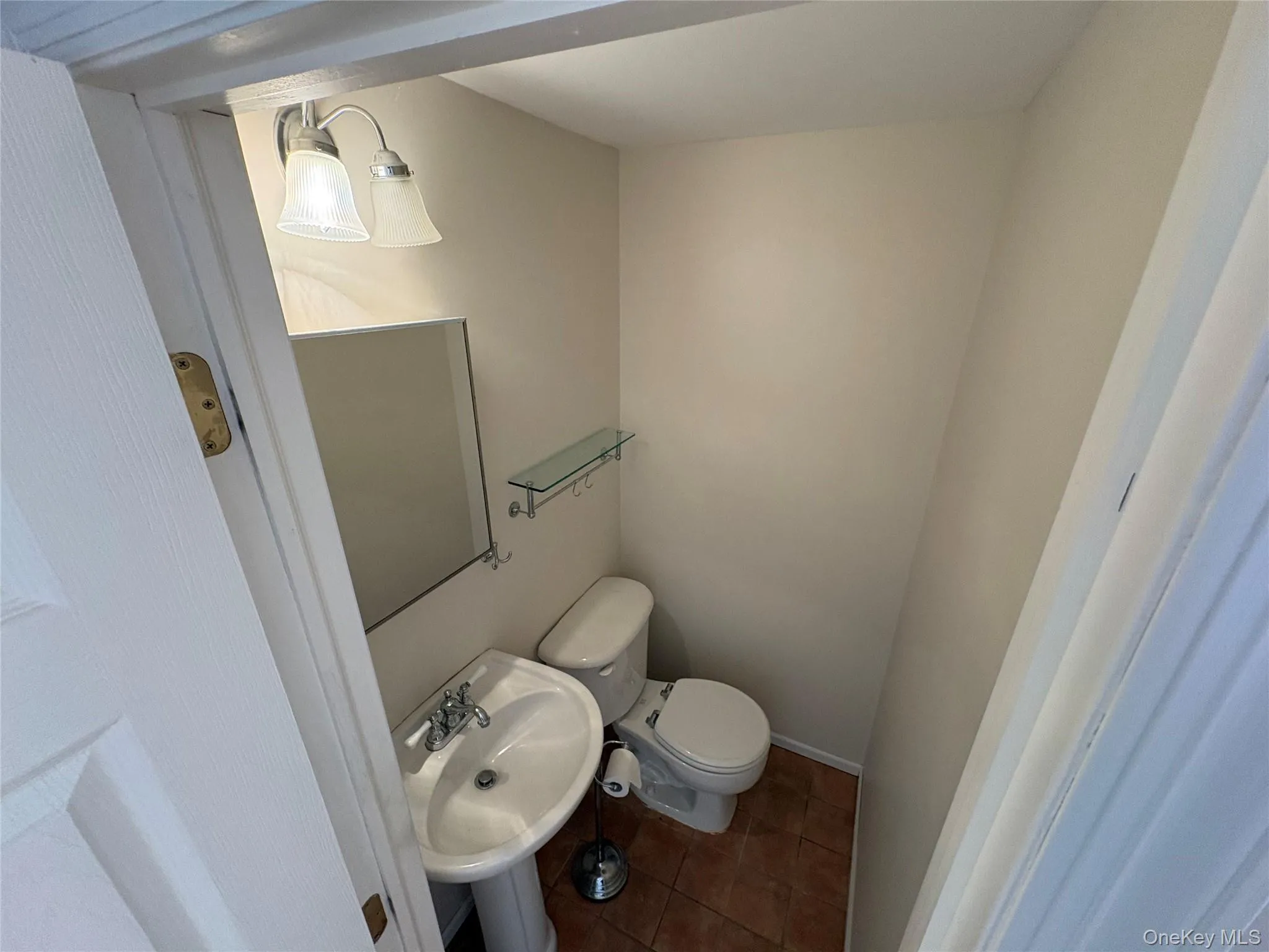 Bathroom featuring tile patterned flooring and toilet Bathroom featuring tile patterned flooring and toilet