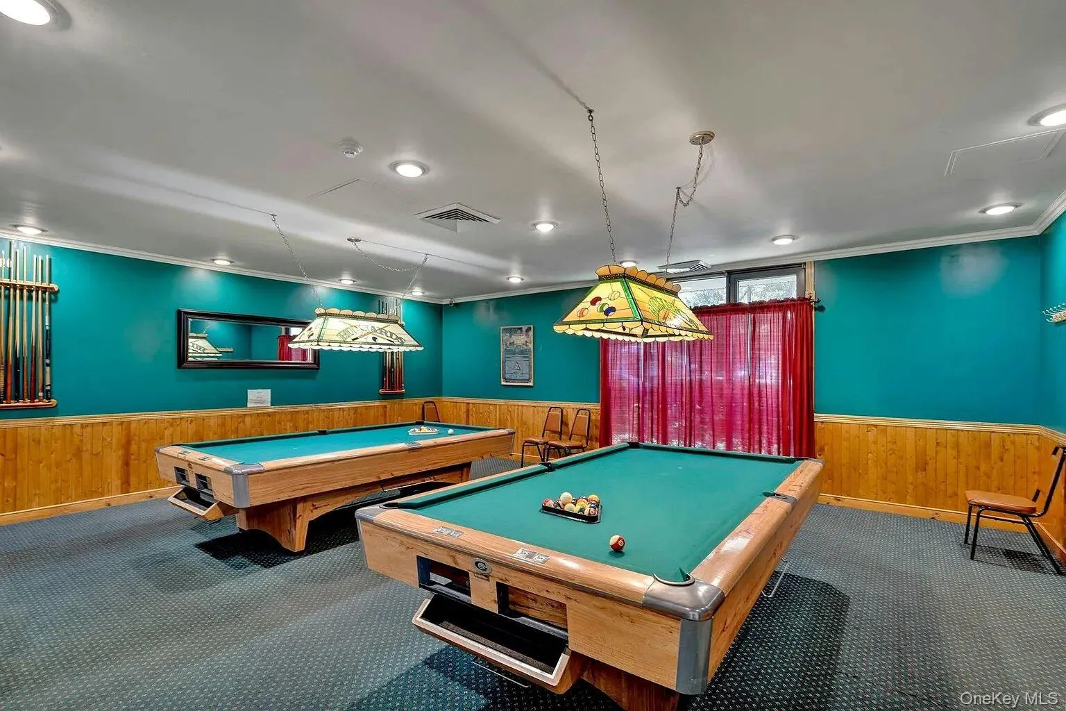 Recreation room featuring wainscoting, wood walls, ornamental molding, and billiards Recreation room featuring wainscoting, wood walls, ornamental molding, and billiards