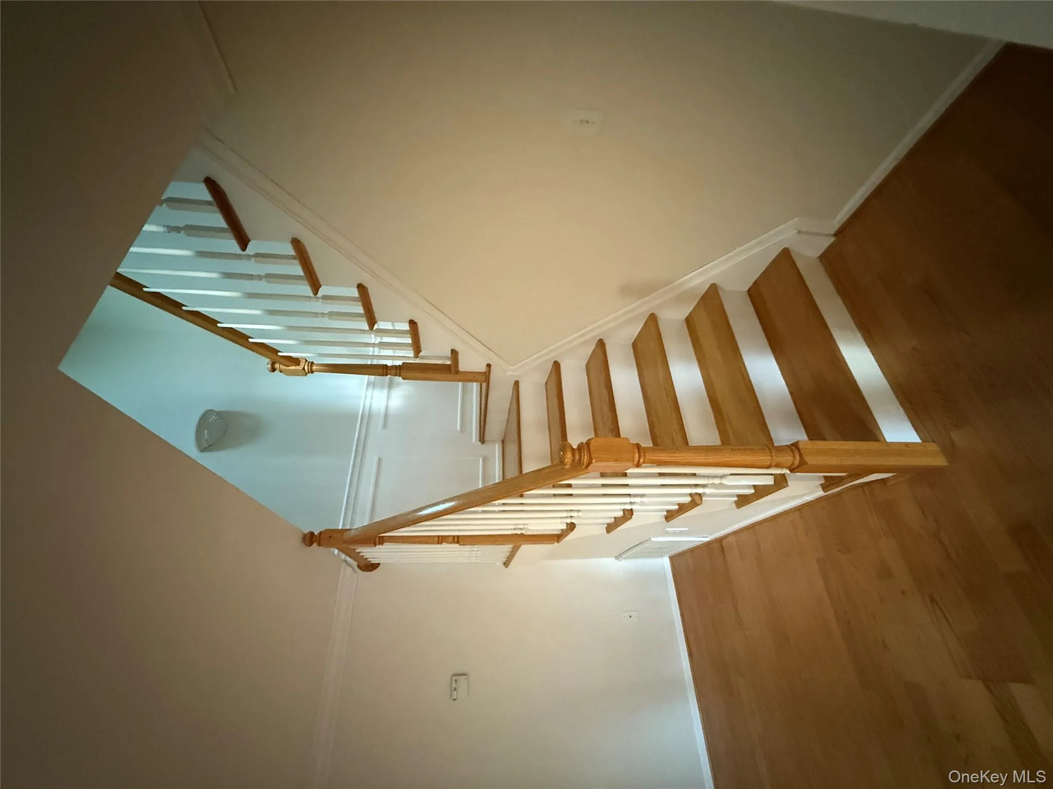 Staircase with wood finished floors and crown molding Staircase with wood finished floors and crown molding