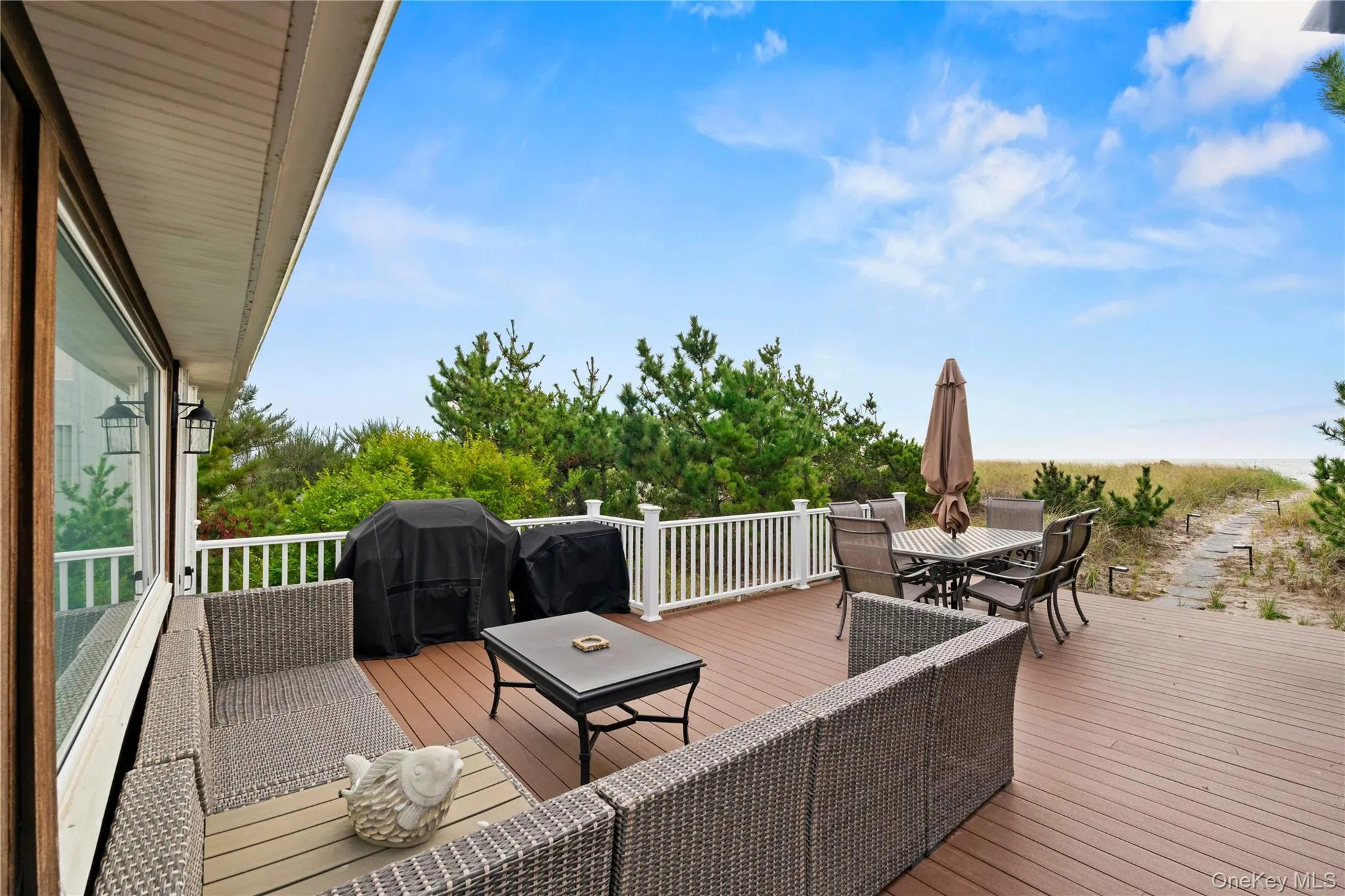 Oceanfront lounge composite deck with outdoor dining space and grilling area Oceanfront lounge composite deck with outdoor dining space and grilling area