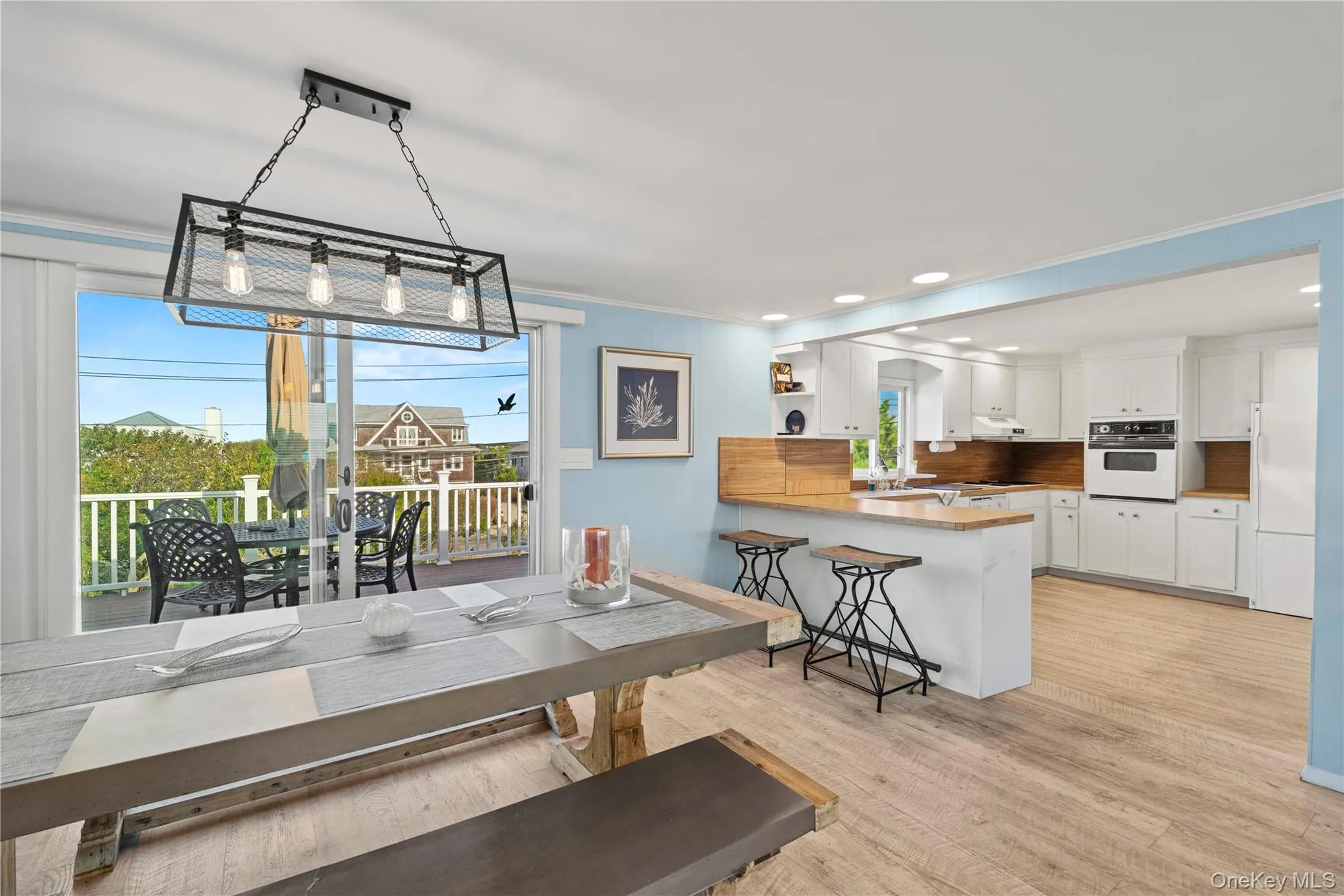 Open layout / Dining area with ornamental molding, light wood finished floors, and recessed lighting Open layout / Dining area with ornamental molding, light wood finished floors, and recessed lighting