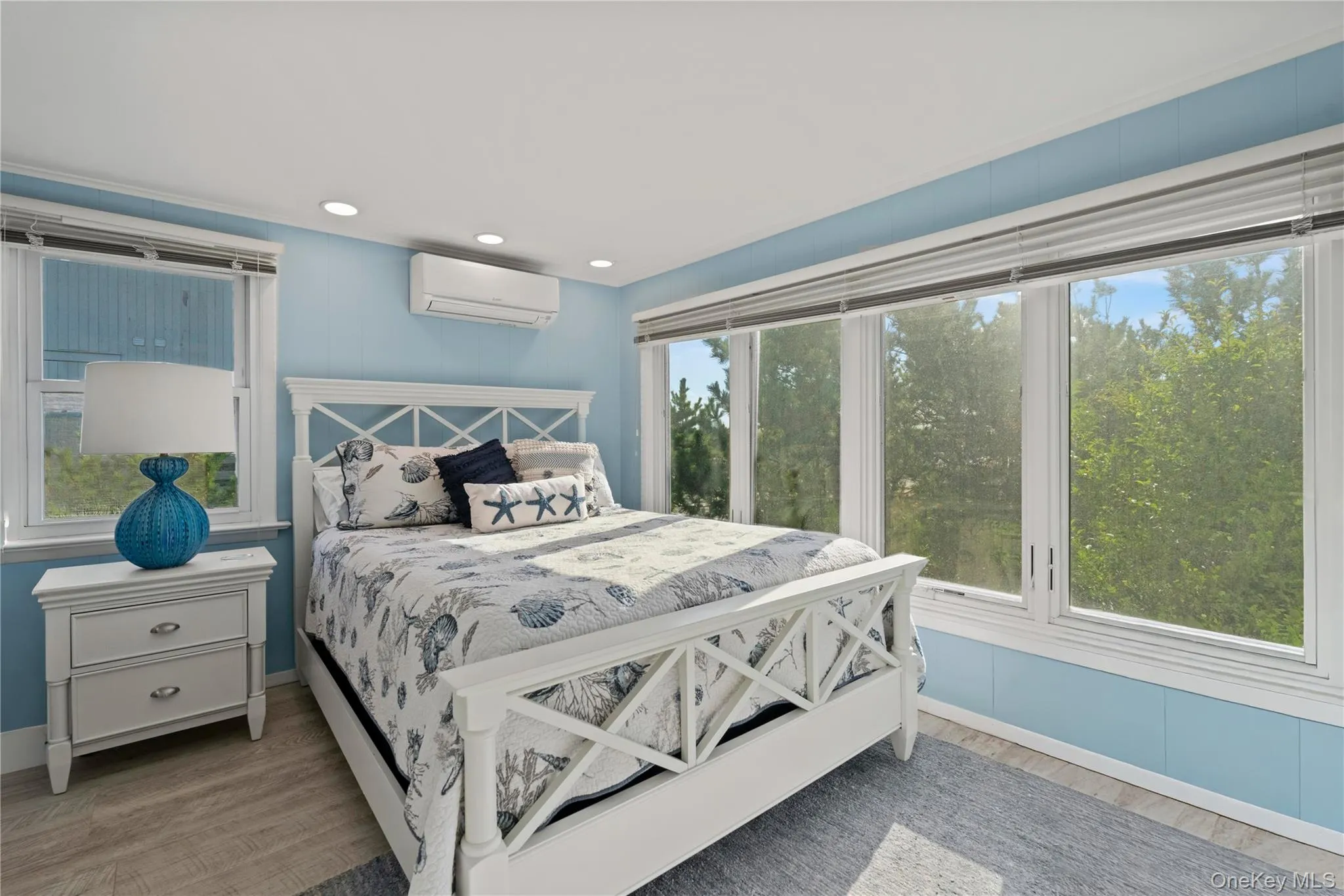 1 of 4 Beds with light wood-style floors, a wall mounted AC, and recessed lighting 1 of 4 Beds with light wood-style floors, a wall mounted AC, and recessed lighting