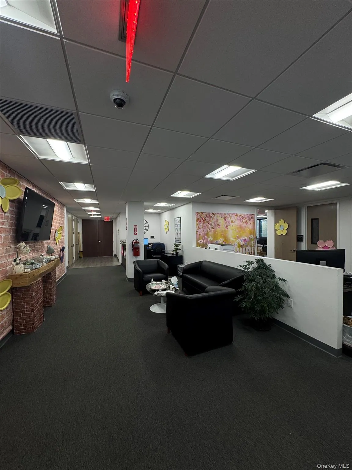 Common area with a paneled ceiling and a surveillance system Common area with a paneled ceiling and a surveillance system
