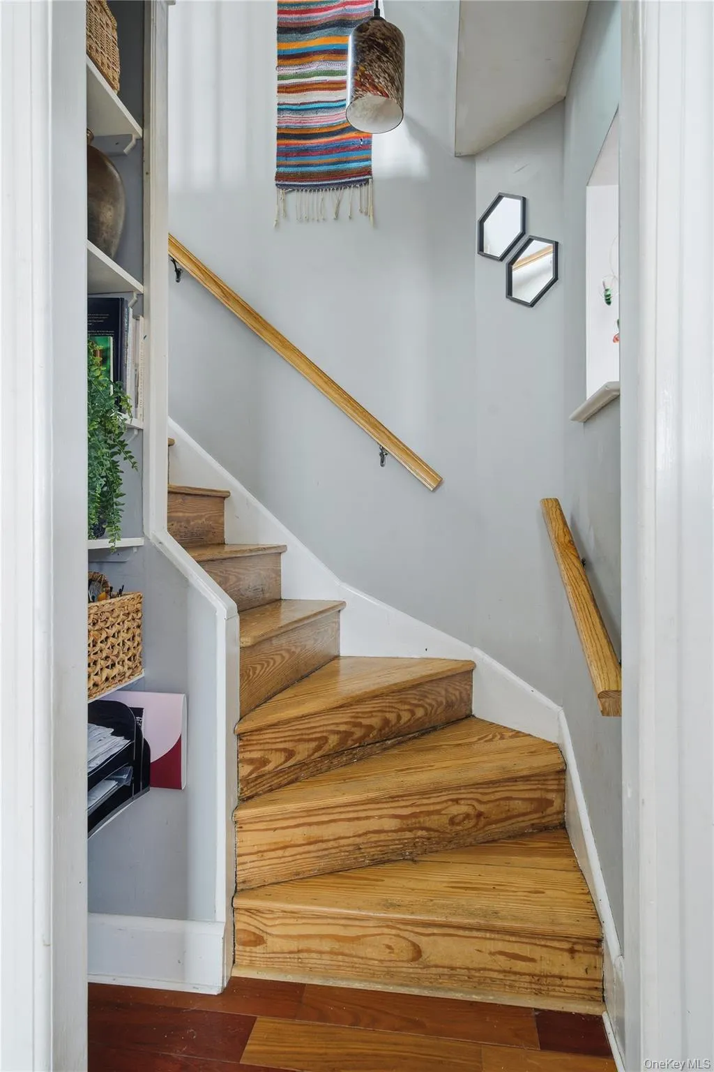 Stairs featuring hardwood / wood-style flooring Stairs featuring hardwood / wood-style flooring
