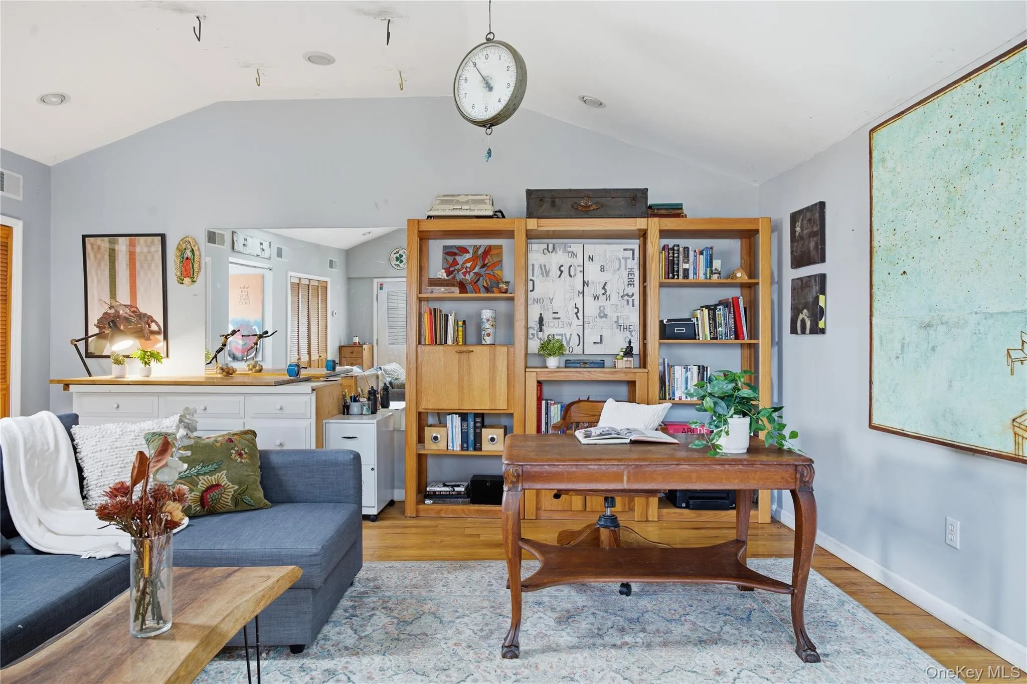 Home office featuring wood finished floors and lofted ceiling Home office featuring wood finished floors and lofted ceiling
