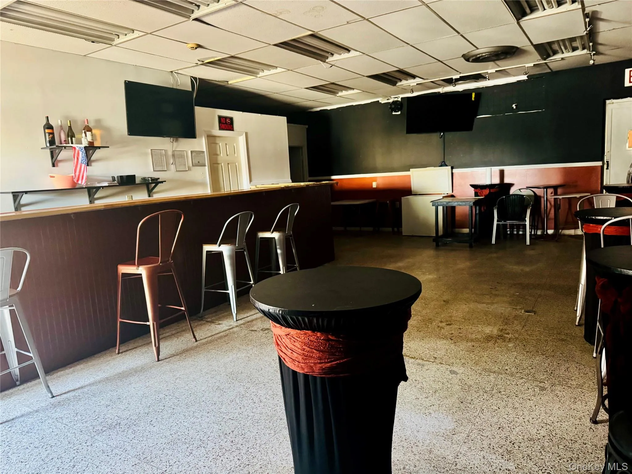 Bar area with a drop ceiling and dark cabinets Bar area with a drop ceiling and dark cabinets