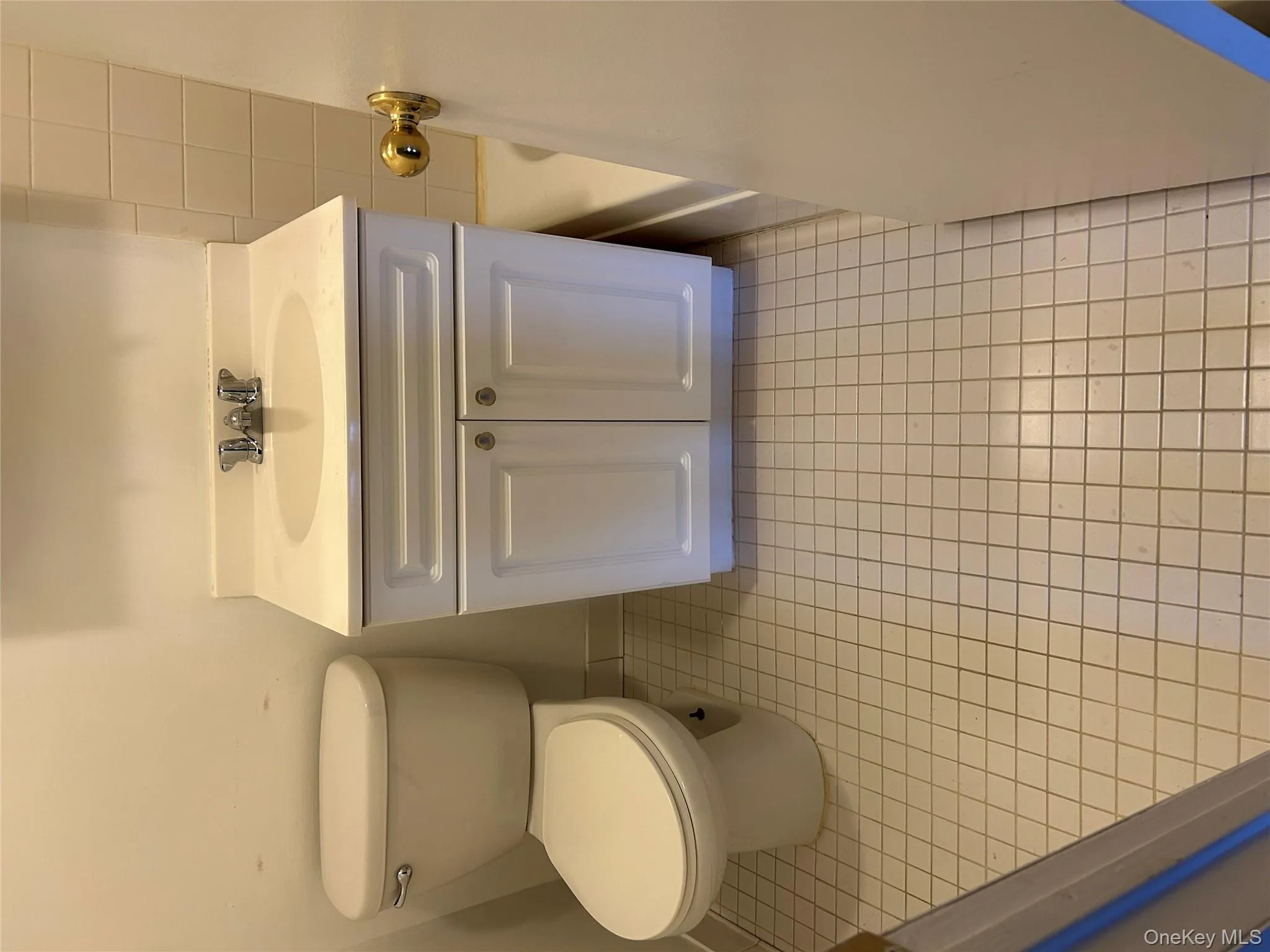 Full bath with light tile patterned floors and vanity Full bath with light tile patterned floors and vanity