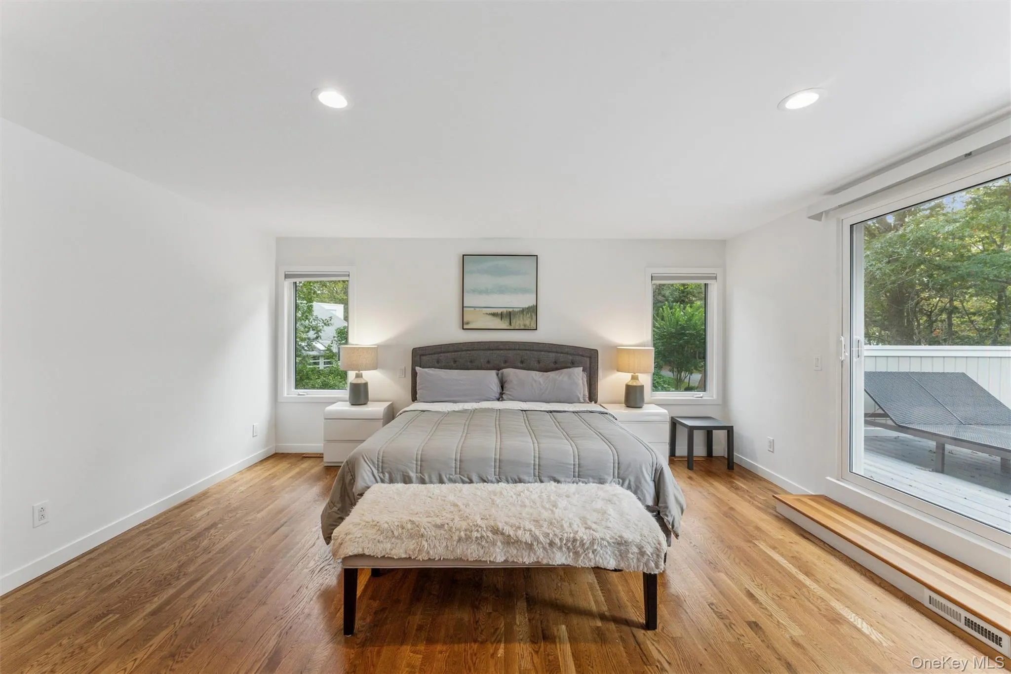 Bedroom with light wood-type flooring, recessed lighting, and access to exterior Bedroom with light wood-type flooring, recessed lighting, and access to exterior