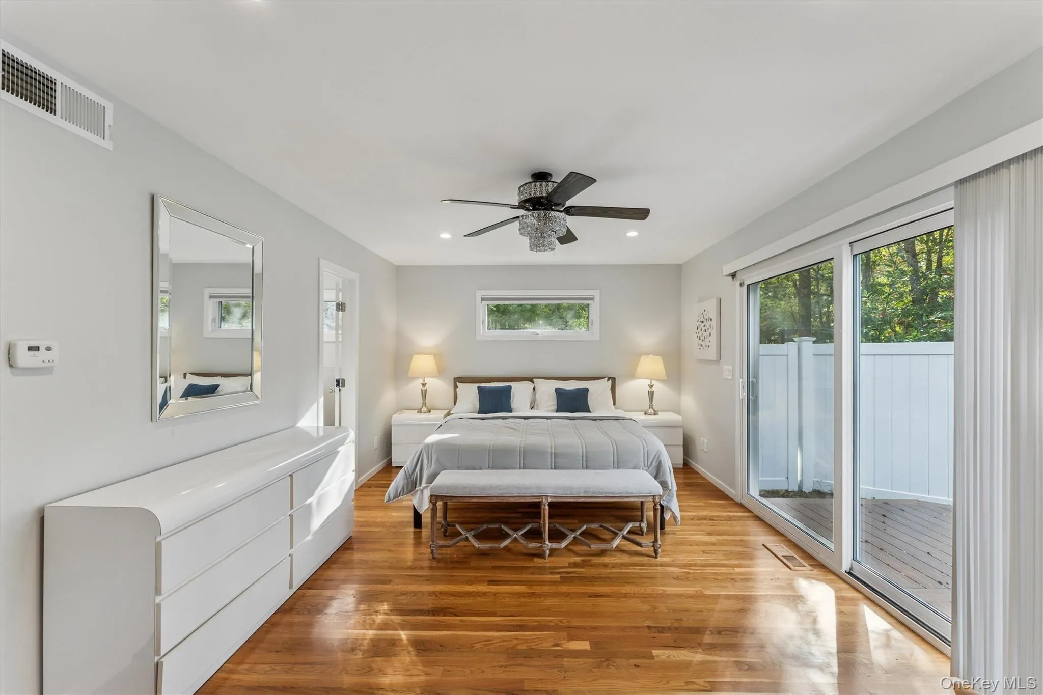 Bedroom featuring wood finished floors, access to outside, recessed lighting, and ceiling fan Bedroom featuring wood finished floors, access to outside, recessed lighting, and ceiling fan